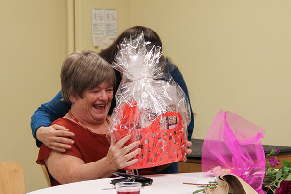 Sylvia Norris, left, smiles at a gift basket she received.