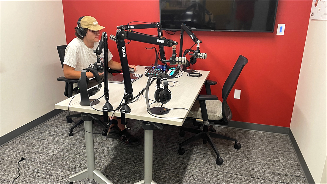 Drew Dennison, Adobe creative consultant, uses a new podcast studio in Kahlert Village. Image courtesy of Tony Sams. Drew Dennison, Adobe creative consultant, uses a new podcast studio in Kahlert Village. Image courtesy of Tony Sams.