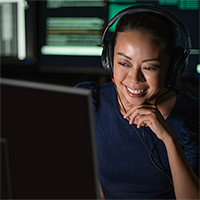 Woman with headphones at a computer.