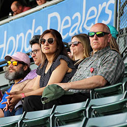 UIT employees watch the ballgame from their seats in the stands.