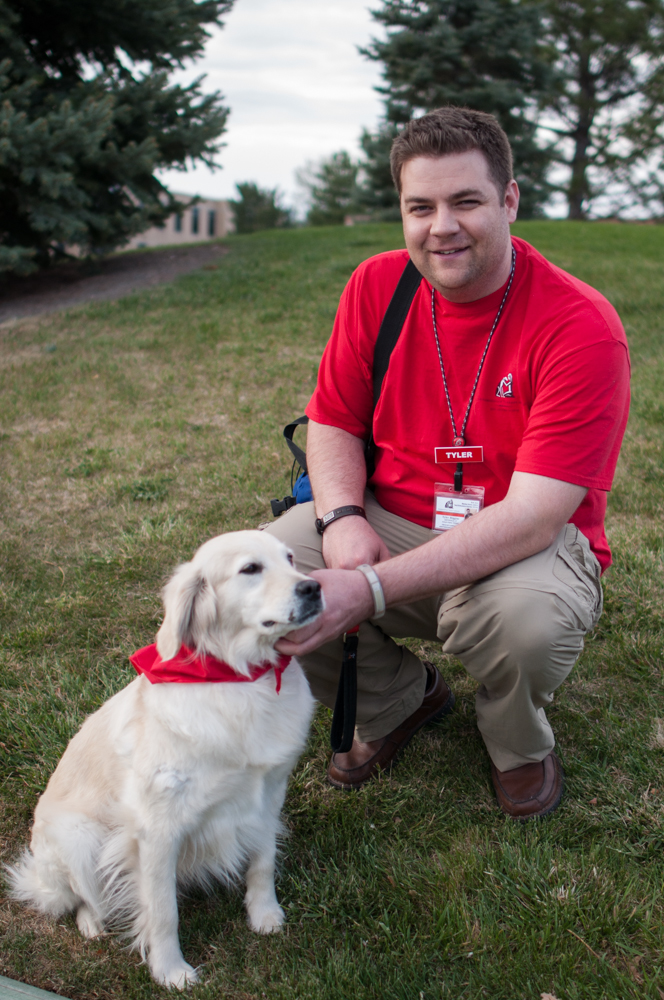 Tyler Higgins, account executive for Unified Communications, and his certified therapy dog, Cookie.